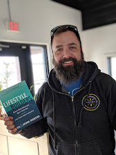 A reader holding a copy of Lifestyle Builders