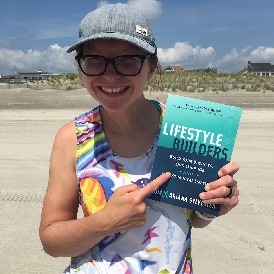 A reader holding a copy of Lifestyle Builders at the beach