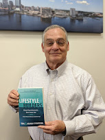 A reader holding a copy of Lifestyle Builders