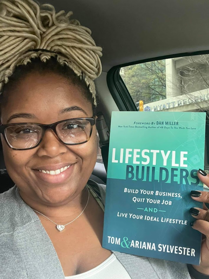 A reader holding a copy of Lifestyle Builders