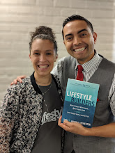 A couple holding a copy of Lifestyle Builders
