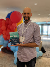 A reader holding a copy of Lifestyle Builders